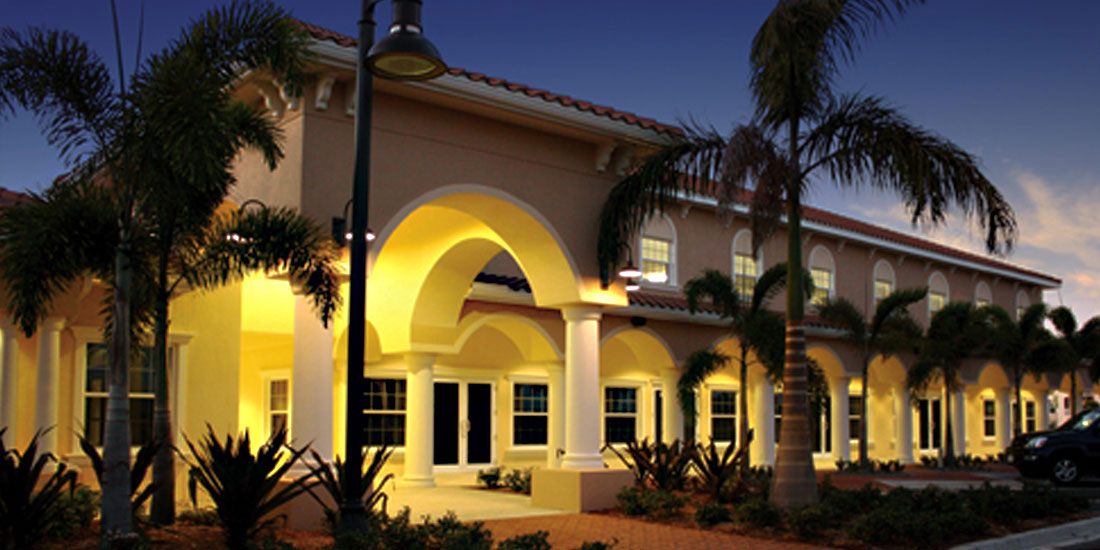 Galleria on Venice Avenue retail complex at night with lighted exterior and palm trees