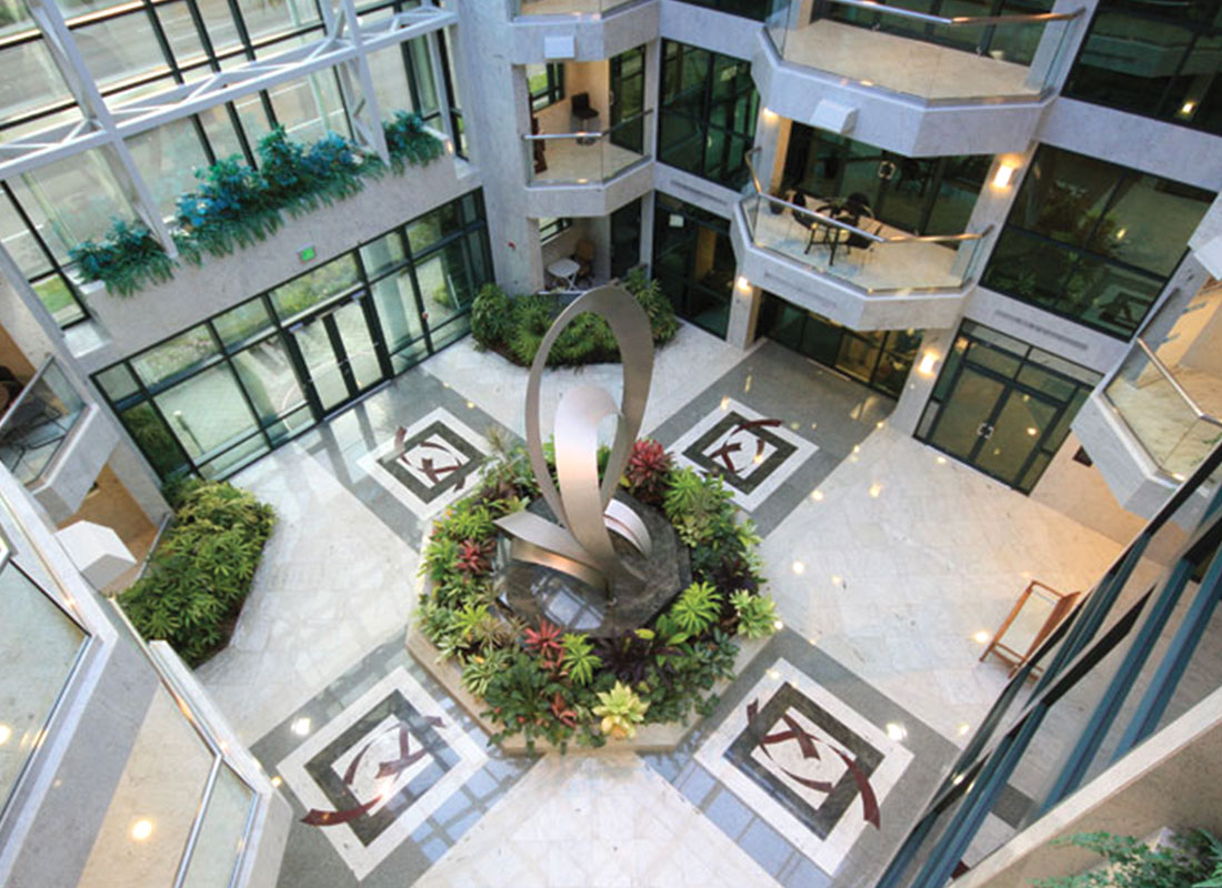 View of marble floored foyer with metal sculpture in center