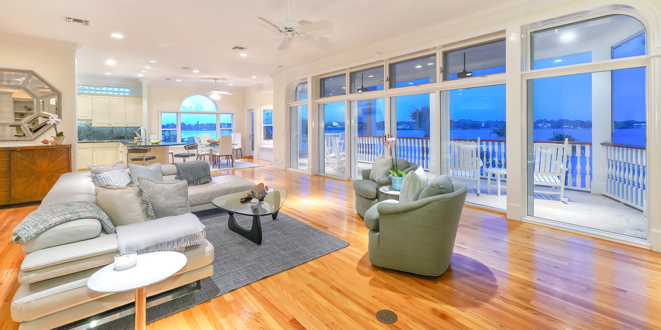 Interior view of luxury modern home with wall of windows looking out to the Gulf of Mexico