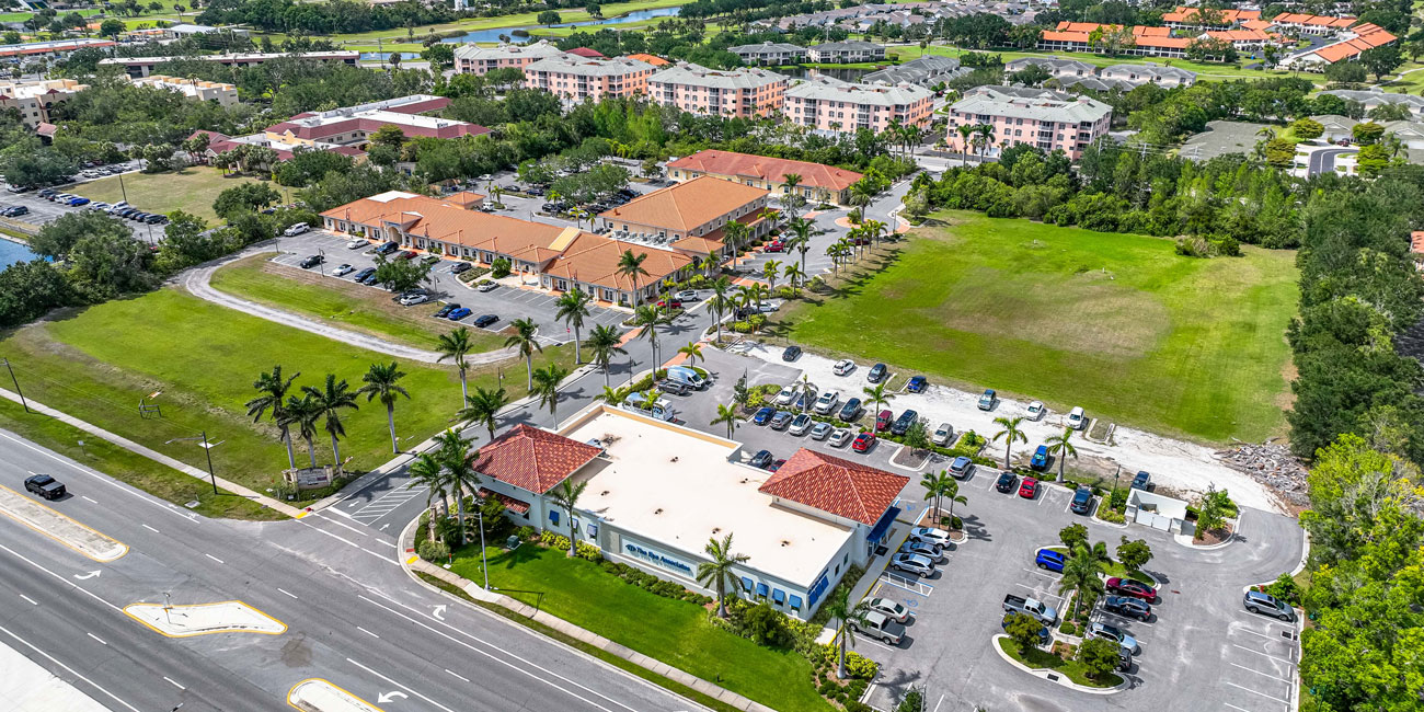 Aerial shot of office and retail plazas showing two parcels of green space